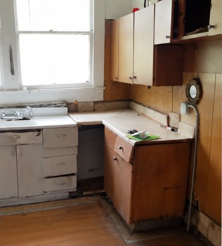 Before: Full kitchen rebuild — cabinets, butcher-block counters, tile and appliances.