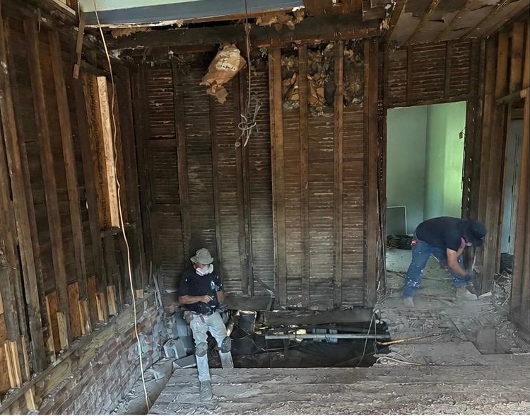 Before: Gutted to the studs — new floor framing, walls, stairs and lighting.