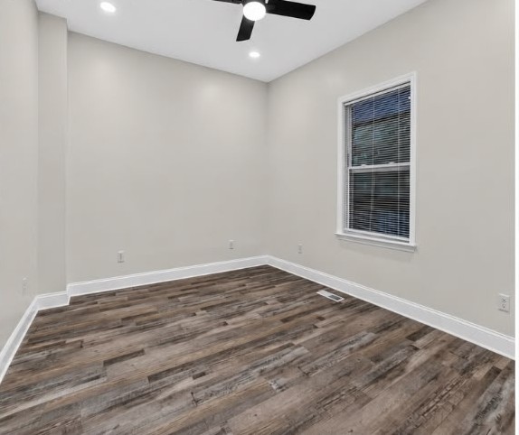 After: Bedroom — rebuilt walls, new window, floors and ceiling fan.