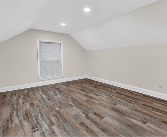 After: Upstairs bedroom — new drywall, window trim, lighting and floors.